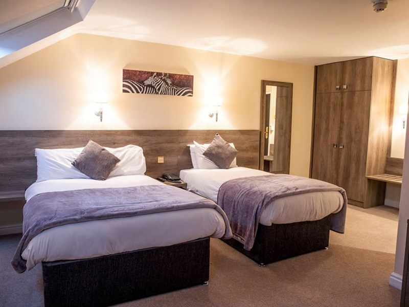 A hotel room with two beds.