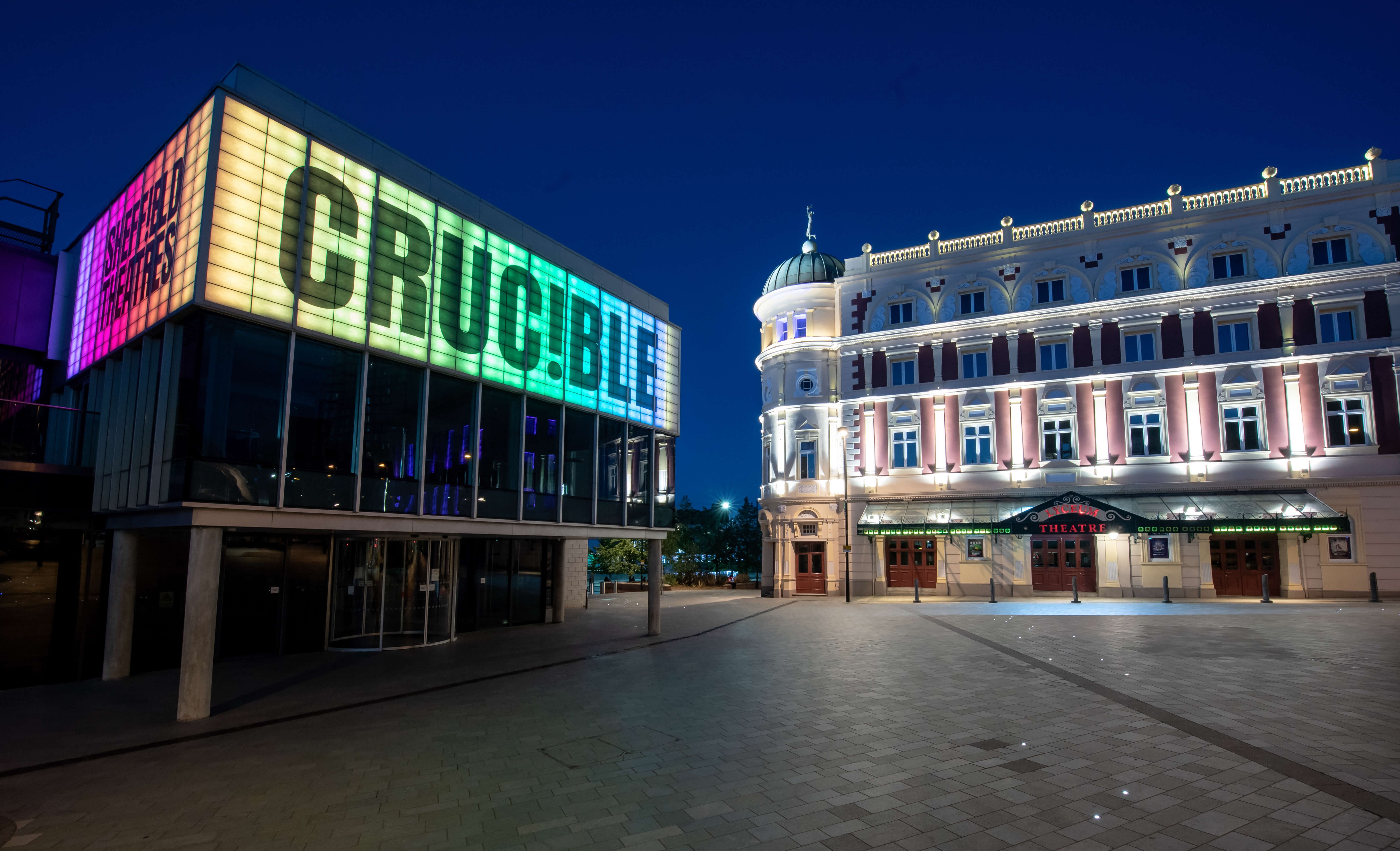 The Crucible Theatre and the Lyceum Theatre lit up at night.