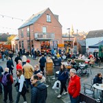 A large crowd of people looking round an outdoor market on Sharrow Vale Road in Sheffield.